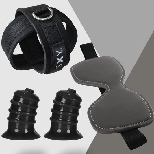 The Roleplay Realness set from Adams Toy Box features a black wrist restraint with a metal ring, a textured blindfold, and two silicone suction cup toys, all arranged artfully on a light and dark gray background for discreet fun.