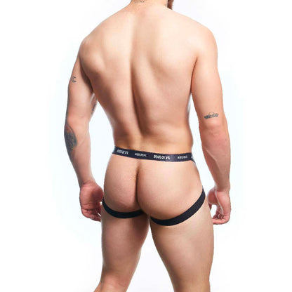 A tattooed person with a short haircut poses from the back in a Good Devil Sexy Men Jockstrap made of Premium Fabric Blend, set against a white background. The waistband reads Good Devil.