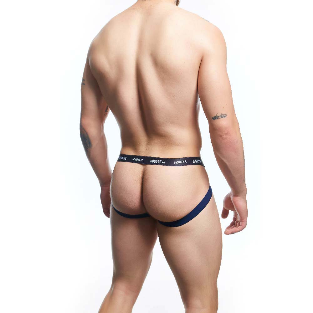 A person modeling the Good Devil Sexy Men Jockstrap is facing away from the camera, highlighting a toned back and legs. The waistband displays Good Devil and accentuates its premium fabric blend against a plain white backdrop, emphasizing its striking design.