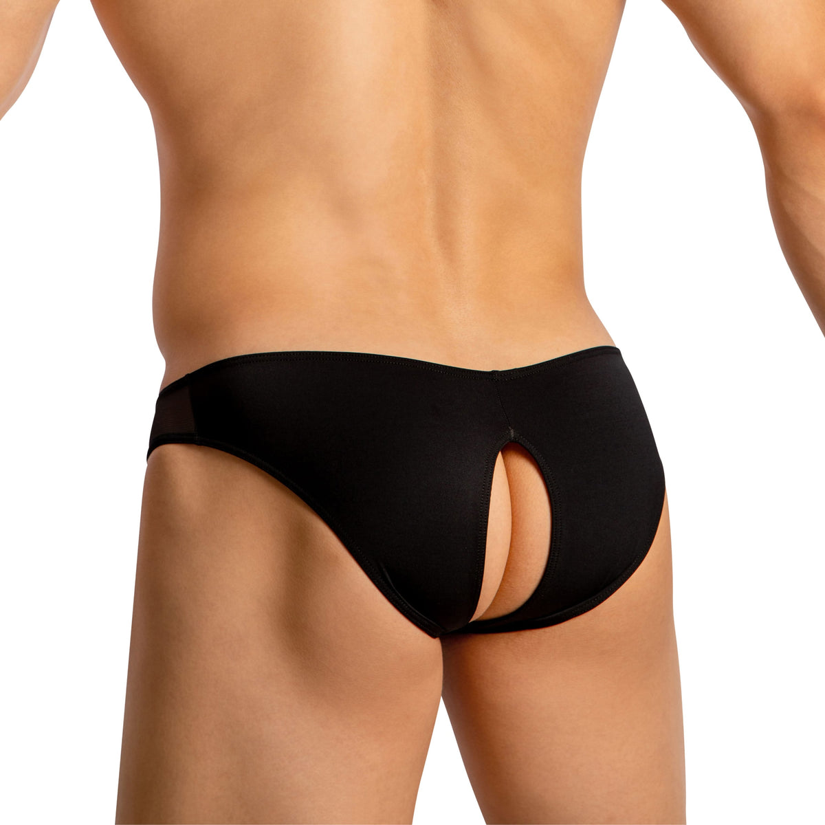A person models Good Devil Mens Crotchless Bikini in black, showcasing a seductive keyhole cutout for luxurious comfort against a plain white background.
