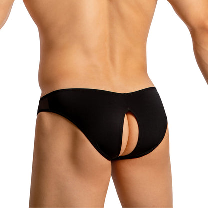 A person models Good Devil Mens Crotchless Bikini in black, showcasing a seductive keyhole cutout for luxurious comfort against a plain white background.