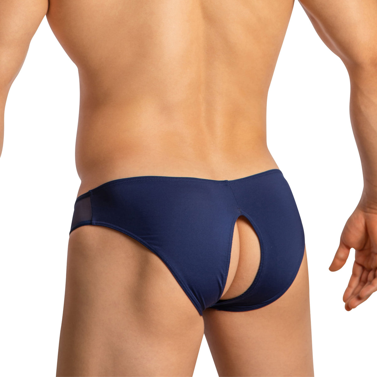 A muscular person, viewed from the back, wears the seductive navy blue Good Devil Mens Crotchless Bikini. The cutout detail enhances their physique as they stand confidently against a neutral white background, radiating luxurious comfort.