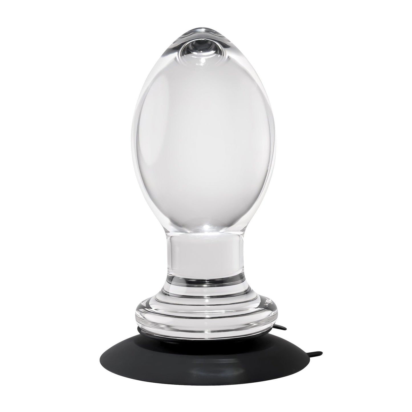 The Gender X Crystal Ball Plug With Suction Cup is showcased against a white background, highlighting its clear glass finish, oval shape, flat base, and smooth reflective surface.