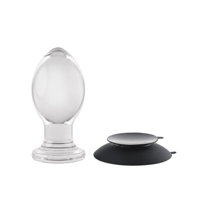 The Gender X Crystal Ball Plug with Suction Cup features a transparent, teardrop-shaped glass design and a round black silicone suction cup with minimalistic aesthetics, all displayed on a plain white background.