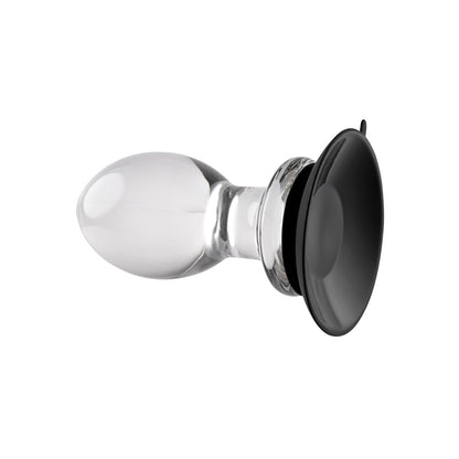 The Gender X Crystal Ball Plug With Suction Cup is an oval, transparent glass object featuring a wide silicone suction cup at one end, ideal for attachment or display. Its smooth and reflective surface resembles a crystal ball.