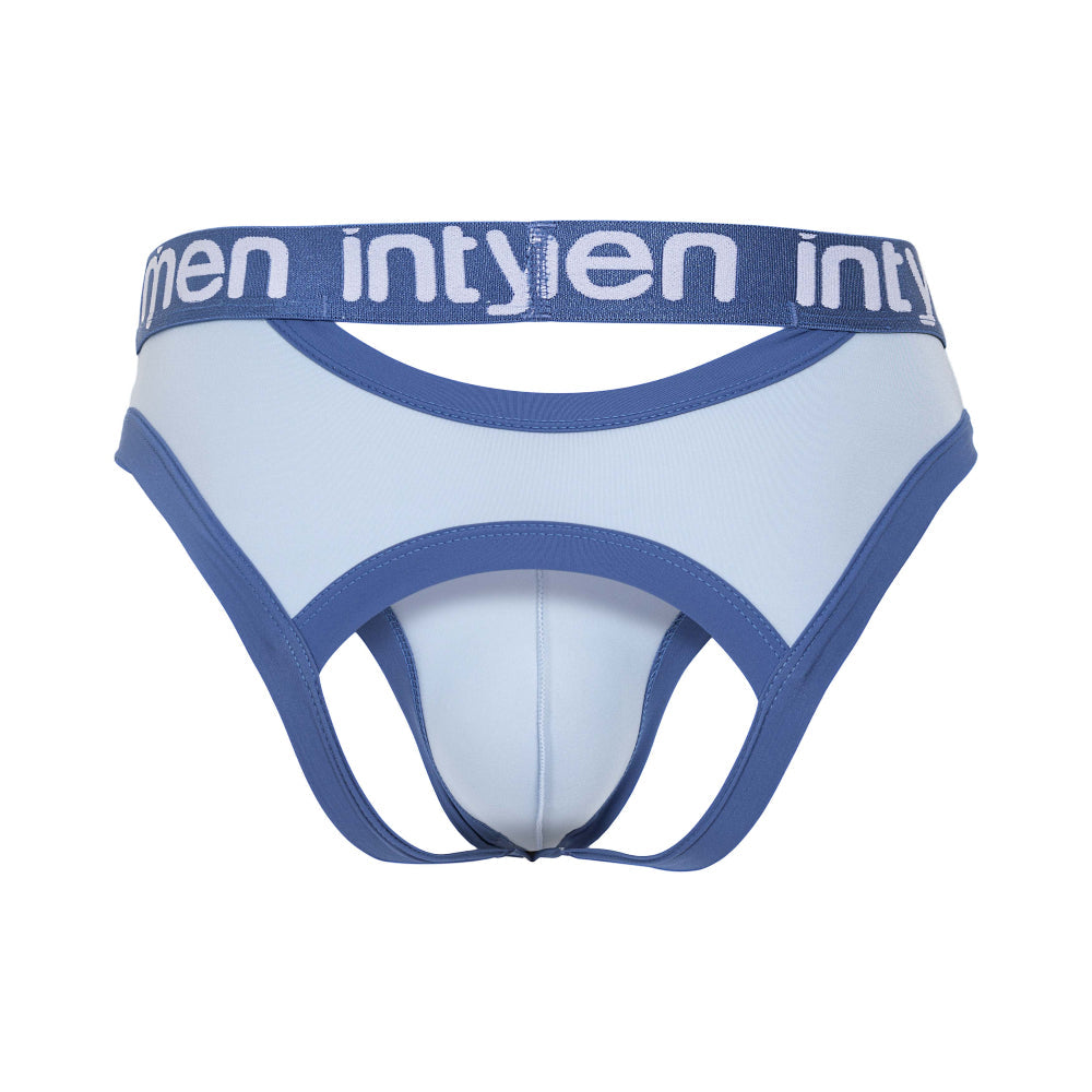 The Intymen Desert Jockstrap Crotchless Underwear features premium light blue fabric with darker blue trim and waistband, displaying the intymen brand in white. It includes cut-out sections and a supportive pouch for a secure fit.