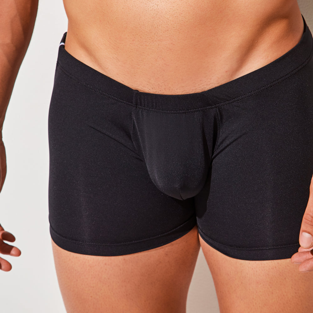 The image shows someone wearing Intymen Good Trunks in black, emphasizing their perfect fit from waist to mid-thigh. The design features premium fabrics for ultimate comfort and style.