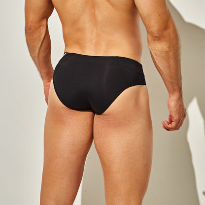Modeling Intymens True Brief Underwear, a person stands back to the camera against a plain, light background. The premium fabric blend and lighting highlight its comfortable slim fit and body contours effortlessly.