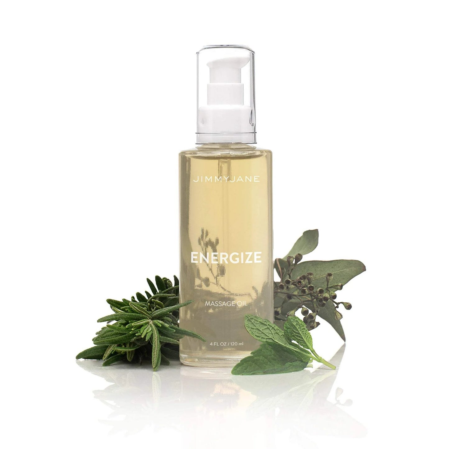 A clear pump bottle of Pipedream Products JimmyJane Energize Massage Oil - 4 oz sits beside fresh sage, mint, and rosemary on a white background, emphasizing its revitalizing aromatherapy botanical ingredients.