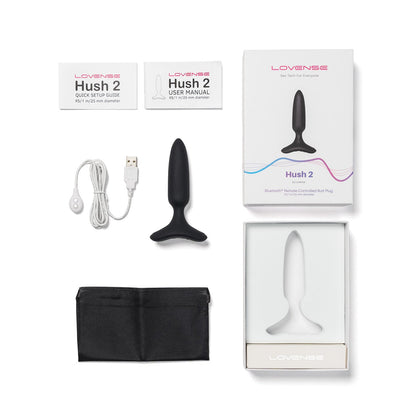 The image displays the Lovense Hush 2 Butt Plug package, which includes a Bluetooth remote-controlled vibrating plug made of 100% silicone. The box features a USB charging cable, quick setup guide, user manual, and black storage pouch neatly arranged around it.