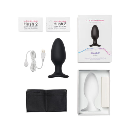 A box with the Lovense Hush 2 Butt Plug includes a black silicone, Bluetooth-controlled vibrating plug, USB charging cable, user manuals, and a storage pouch. The packaging promotes it as your silent partner in pleasure.