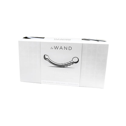 The Le Wand Stainless Steel Bows box features a mainly white design with a grayscale image of the elegantly curved wand. Text highlights its non-porous, body-safe, and dual-ended delight functionality, suitable for temperature play.