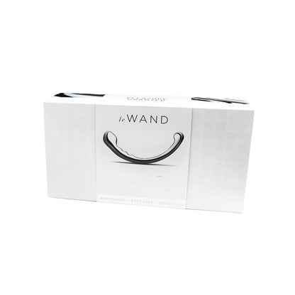 A white box featuring Le Wands Stainless Steel Swerve displays an image of its sleek, curved design. Packaging highlights features like non-porous material, body-safe assurance, and unbreakable quality—ideal for those desiring a stainless steel sensation.