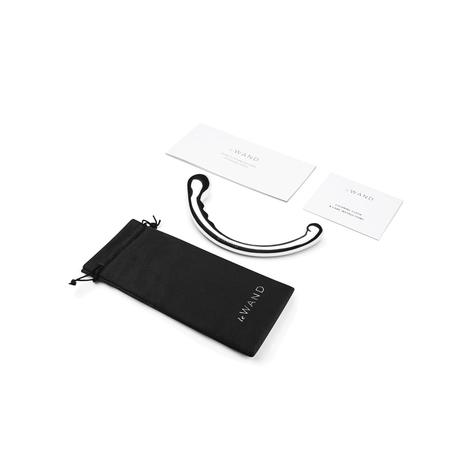 A black, wand-shaped Le Wand Stainless Steel Swerve with a curved design rests beside a black drawstring pouch. Two white cards about the product lie nearby, all elegantly displayed against a pristine white background.