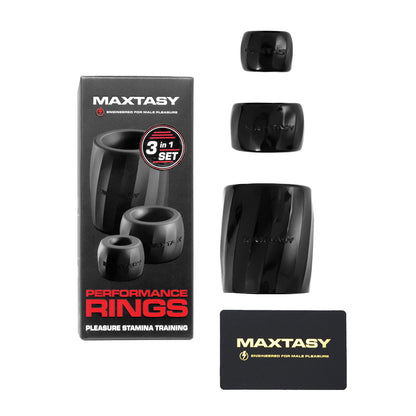 The Maxtasy Performance Rings set features three black rings for pleasure stamina training, displayed alongside their packaging. The package highlights 3 in 1 set, includes a Maxtasy card, and the body-safe materials ensure enhanced erection and endurance.