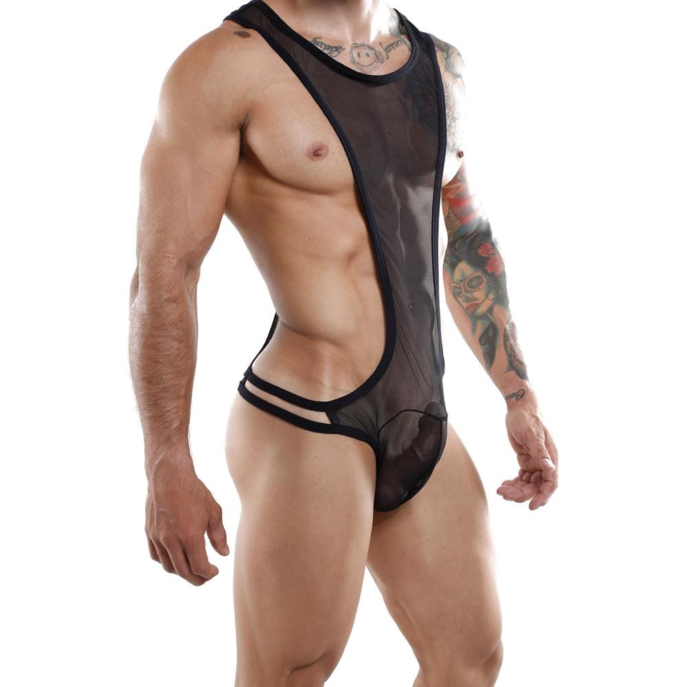 Wearing the Miami Jock Body Suit by Miami Jock, a revealing black mesh bodysuit with cutout sides, a person exudes playful style. The luxurious fabric highlights their tattoos as they stand against a plain white background.