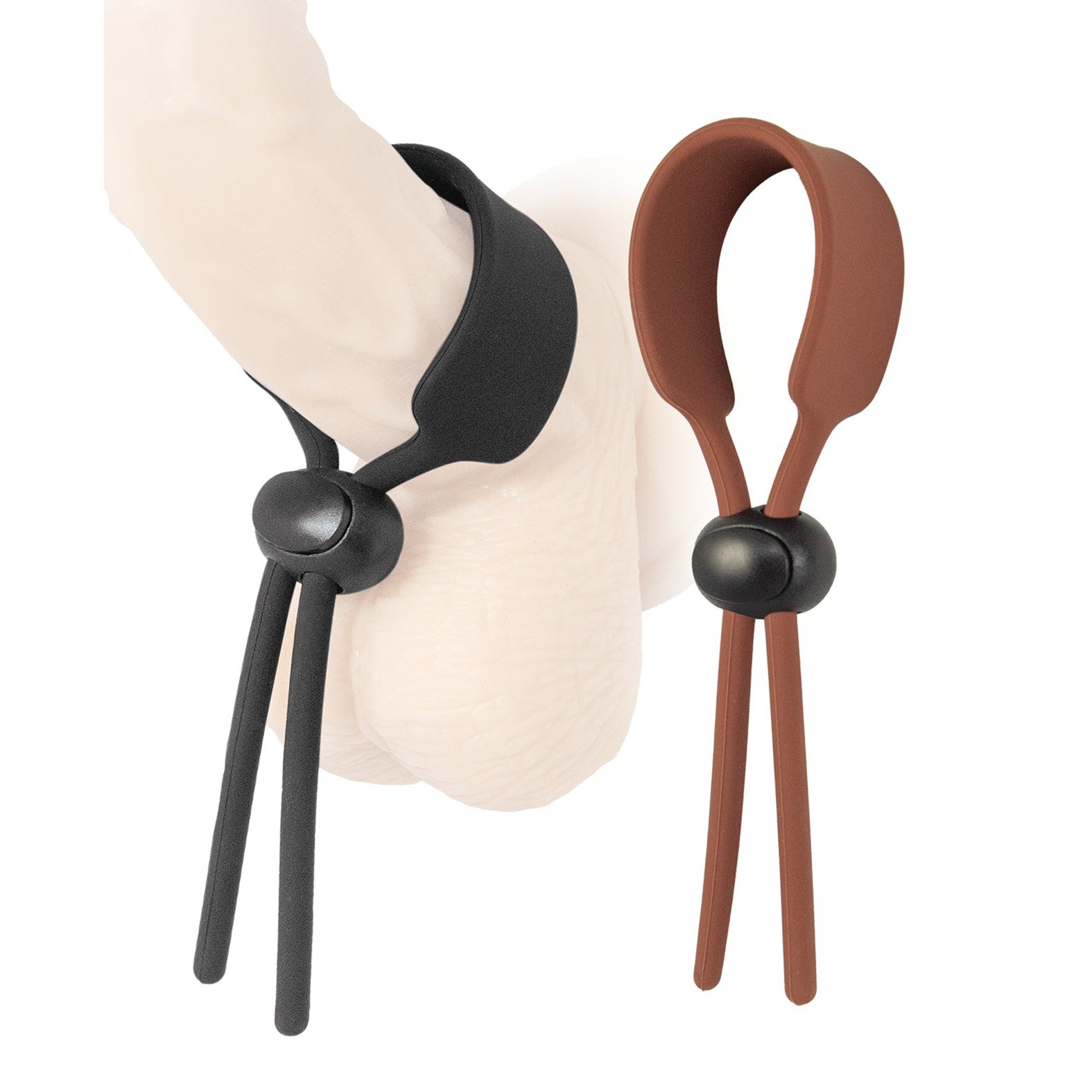 Nasstoys Cock Loops Adjustable Cock Ties, crafted from body-safe silicone in black and brown, feature loops and small balls for easy adjustment. They are perfect for personalized pleasure around any cylindrical shape and showcase their versatility on a sleek white surface.