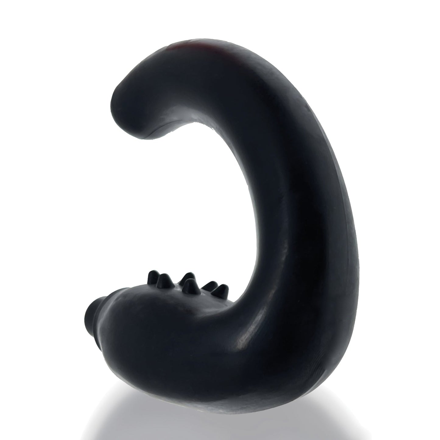 A black S-shaped object with small protrusions along its curve stands upright on a reflective surface, resembling the sleek design of a Hunky Junk Hummer Vibe Prostate Pegger, set against a plain white background.