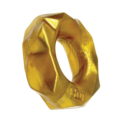 A geometric, donut-shaped sculpture with a metallic gold finish draws inspiration from cockrings. Its faceted surface adds texture, and Pillow is subtly engraved on one side, reflecting the playful design ethos of Hunky Junks Fractal Cockring.