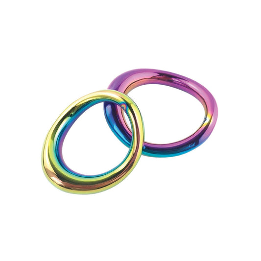 Two stainless steel Plesur 1-3/4 Metal Cock Rings with an irregular, smooth design feature a multicolored rainbow gradient of yellow, green, blue, and pink. Overlapping on a plain white background, these rings hint at enhanced performance for the daring explorer.