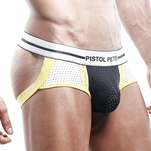 The image shows someone wearing a Pistol Pete Jockstrap with a distinctive white and yellow waistband. The breathable mesh pouch has small perforations, and the yellow side straps enhance the designs contrast. The persons torso and upper legs are visible, emphasizing its revealing back style.