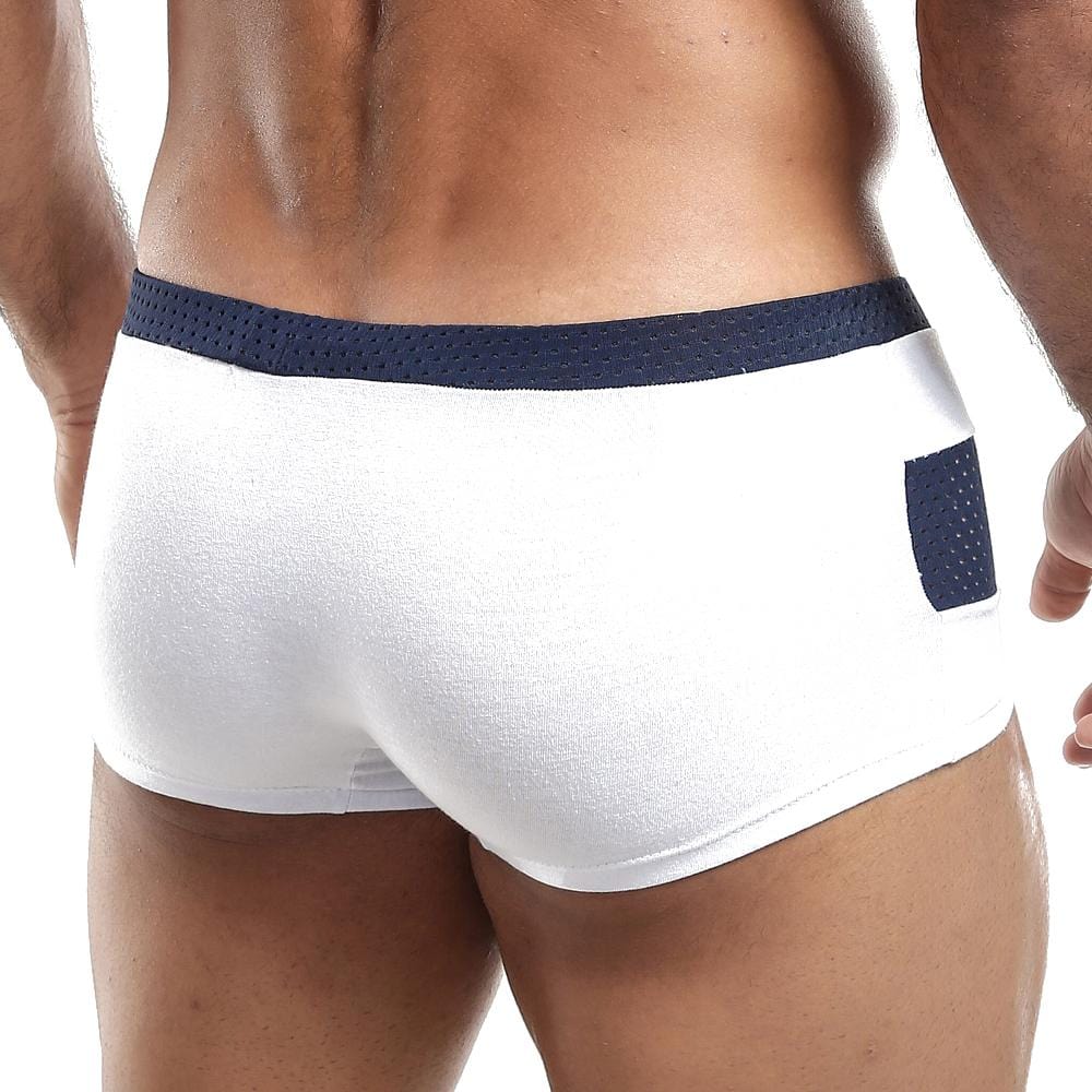 A person models the Pistol Pete Boxer Trunk, featuring a navy waistband and a small navy back pocket; the image accentuates the lower back and upper legs, highlighting the supportive pouch for enhanced comfort.