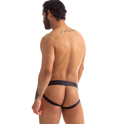A man with tattoos on his upper back and arm wears the 665 Stealth Jockstrap by 665 inc, showcasing dark hair and a trimmed beard against a plain white background.