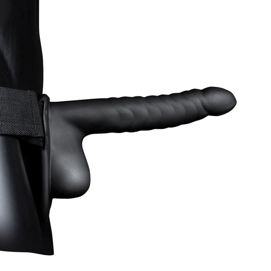 The Shots Ouch 8 Ribbed Hollow Strap-On With Balls in black features a ribbed texture and ergonomic shape, secured to a waist strap. Made from body-safe, phthalate-free materials, it includes a side handle for support, and its design is accentuated by the sophisticated curved form.