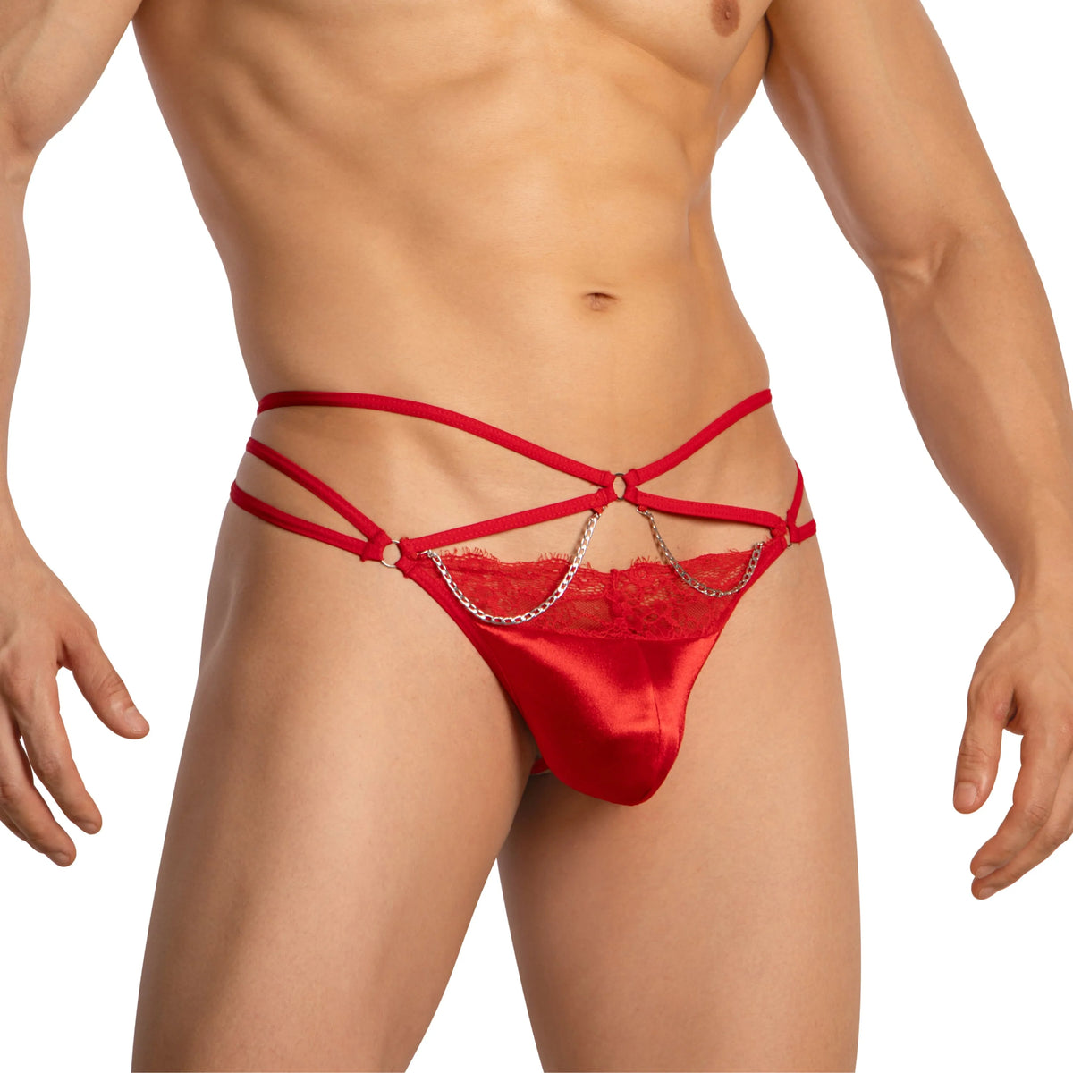 A person models Secret Male Mens G Strings Spicy Lingerie, featuring seductive red satin with lace, intricate strappy details, metal chains, decorative rings, and a snug fit contoured pouch. The neutral background beautifully highlights the design by Secret Male.