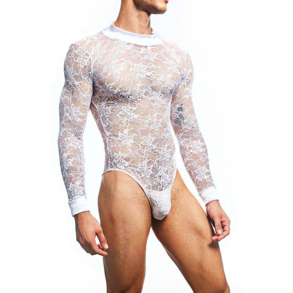 Someone models the Secret Male Mens Lingerie Sexy Bodysuit against a plain white backdrop. The transparent, body-hugging lace showcases intricate patterns as they pose with one arm relaxed, exuding elegance and charm.