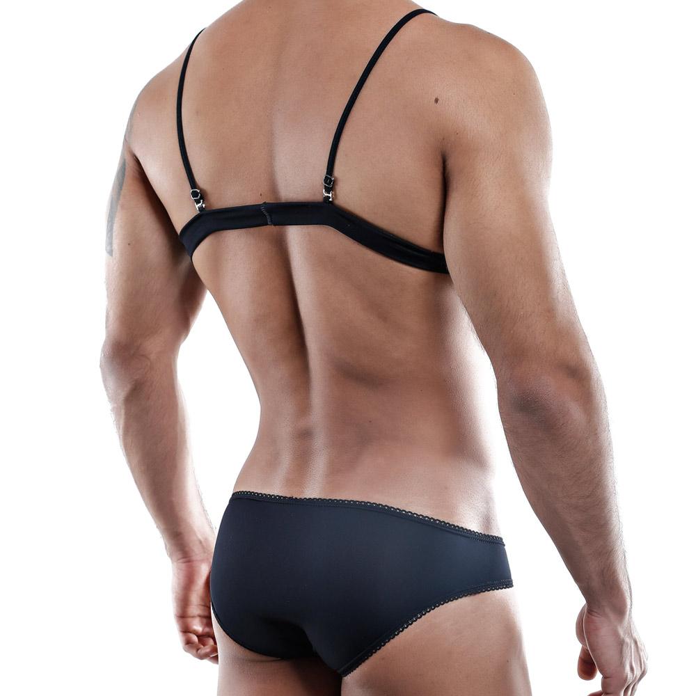 A person stands with their back to the camera, exuding confidence in black lingerie. Their muscular back and arms contrast a plain white background, embodying a sensual design reminiscent of the Secret Male Tops by Secret Male.
