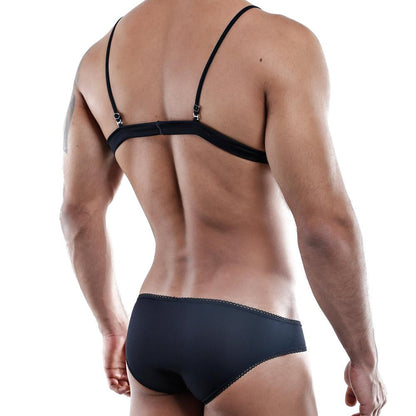 A person stands with their back to the camera, exuding confidence in black lingerie. Their muscular back and arms contrast a plain white background, embodying a sensual design reminiscent of the Secret Male Tops by Secret Male.