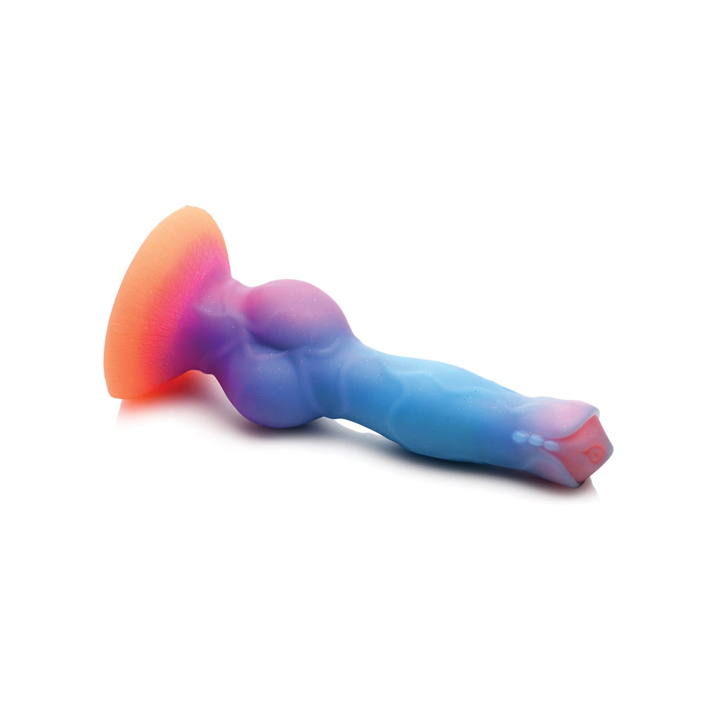 The Creature Cocks Space Cock Silicone Alien Dildo, with a vibrant glow-in-the-dark design of smooth purple to blue hues and a soft orange flared base, rests on a white surface.