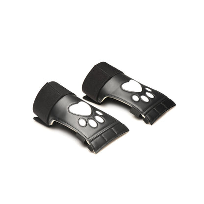 A pair of black wrist guards from the Master Series Pup Arsenal Set by Master Series features white paw print designs on top. They are displayed on a white background and angled slightly to the left.