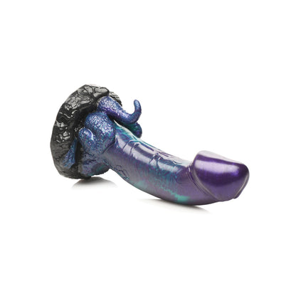 The Creature Cocks Dino Dick Silicone Dild is a purple and black fantasy-style toy with intricate textures and a distinctive, dino-themed design featuring decorative swirls and curves, showcased on a plain white background to highlight its prehistoric charm.