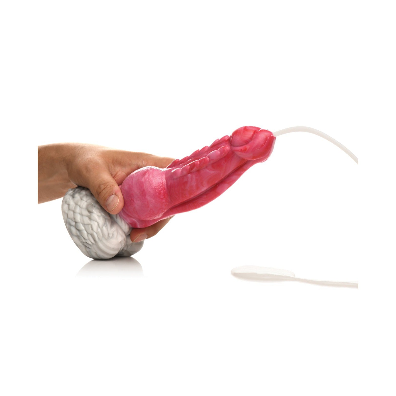 A hand holds the Creature Cocks Resurrector Phoenix Squirting Silicone Dildo, modeled after male anatomy with intricate internal pink and white structures. Crafted from body-safe materials, a tube extends from the end for a squirting fantasy experience.