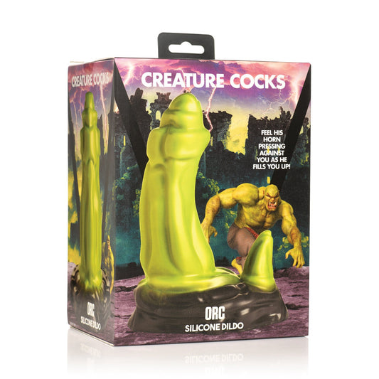 The image showcases the box for the Creature Cocks Orc Silicone Dildo, featuring vibrant artwork of a green orc in a mystical landscape, ideal for those seeking monster fantasy adventures.