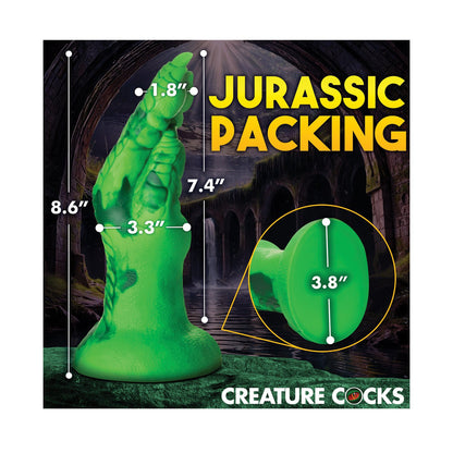 The Creature Cocks Raptor Claw Fisting Silicone Dildo is a green, textured silicone toy shaped like a Raptor Claw with dimensions: 8.6, 3.3, 1.8, 7.4, and a base width of 3.8. The text Jurassic Packing adorns the design, ideal for hands-free riding fantasies under the Creature Cocks brand.