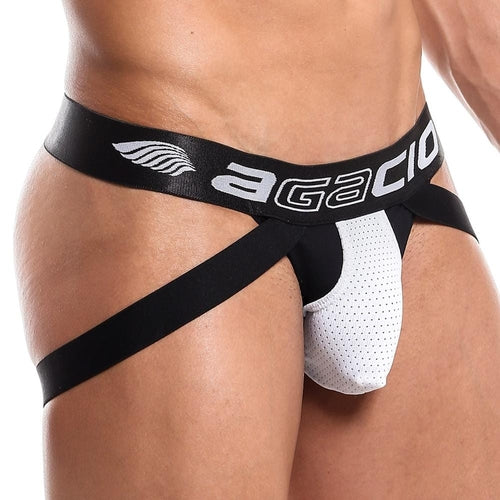 A close-up showcases a man wearing the Agacio Thriller Jockstrap, featuring Agacio on the waistband, wide black straps, and a perforated pouch, with emphasis on the midsection.