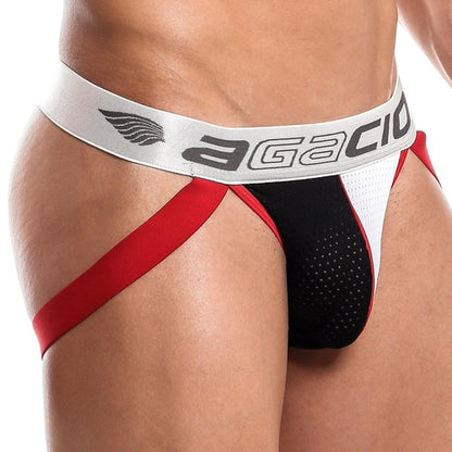 A person models the Agacio Dont Stop Jockstrap, featuring a red and black athletic design with a bold white waistband displaying the Agacio logo. The mesh fabric and supportive red straps emphasize its sporty look.