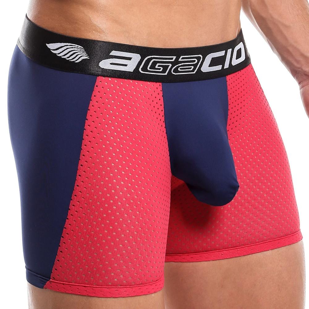 A person wearing Agacio Beat It Boxer, designed in red and navy blue mesh with a black waistband showing the Agacio brand. The comfortable fabric, featuring small perforations for breathability, includes a contour pouch magic for perfect support.