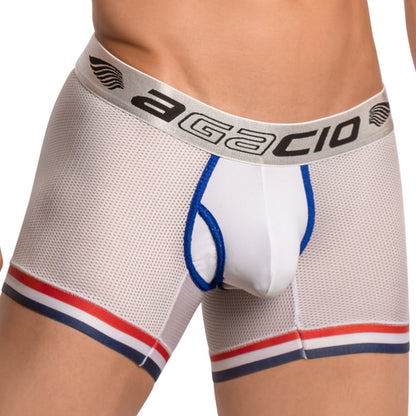A model wears Agacio Atlantis Boxer Trunk, featuring white mesh boxer briefs with blue, red, and black trim. The comfortable waistband is black with Agacio in bold letters, and blue piping adds a stylish touch to the front pouch.