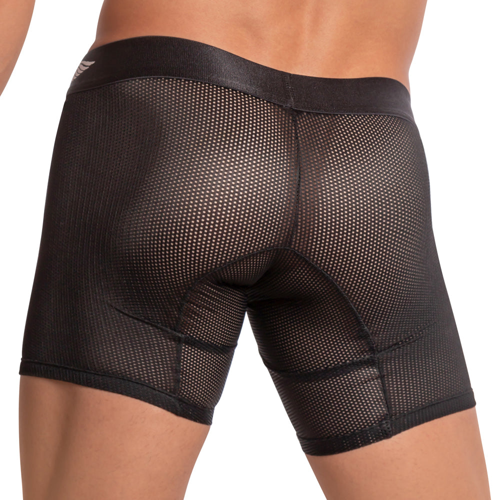 A person is wearing Agacio Scuba Boxer Trunk shorts with a black mesh design. The image showcases the side and back, emphasizing the snug fit, transparent texture, breathable fabric, and supportive pouch for comfort.