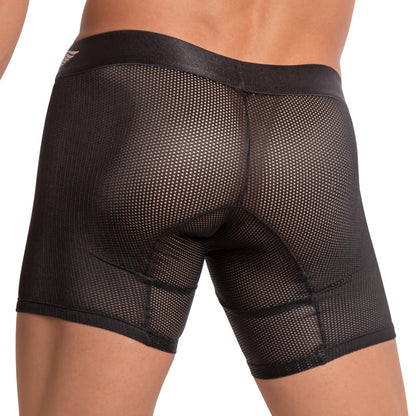 A person is wearing Agacio Scuba Boxer Trunk shorts with a black mesh design. The image showcases the side and back, emphasizing the snug fit, transparent texture, breathable fabric, and supportive pouch for comfort.
