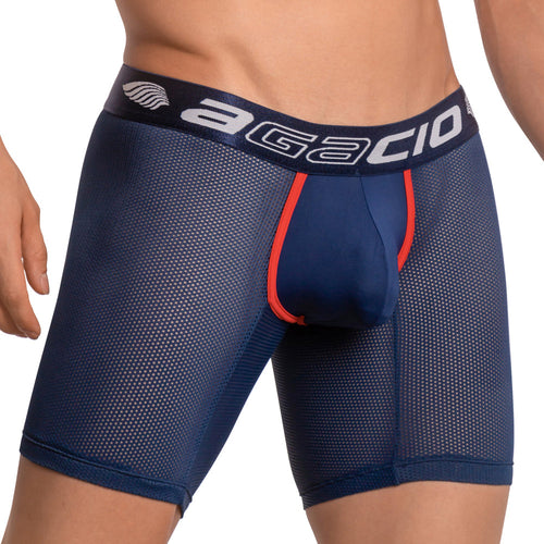 A person is wearing Agacio Scuba Boxer Trunk—a breathable, snug-fitting dark blue mesh brief with red trim and a branded waistband. The image spotlights the supportive pouch from the upper thigh to the waist.