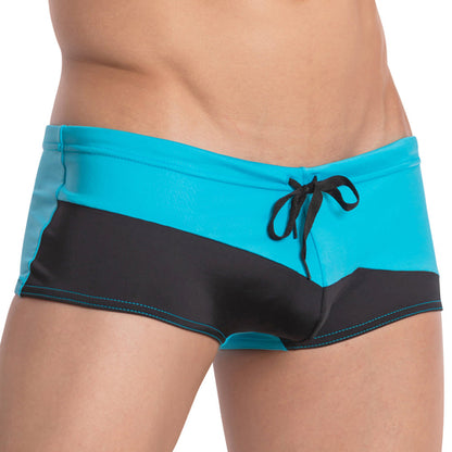 The Agacio Ocean Swim Trunk by Agacio showcases a stylish two-tone design in blue and black, featuring an adjustable drawstring for a secure fit and a diagonal black stripe adding a dynamic touch from waist to mid-thigh.