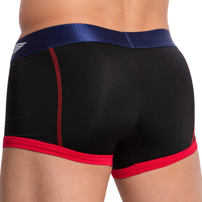 A person wearing Agacio Stretch Boxer Trunk in black and red featuring a blue waistband and a small wing logo on the side. The image emphasizes their lower back and waist, demonstrating the comfort of the double-stitched pouch design.