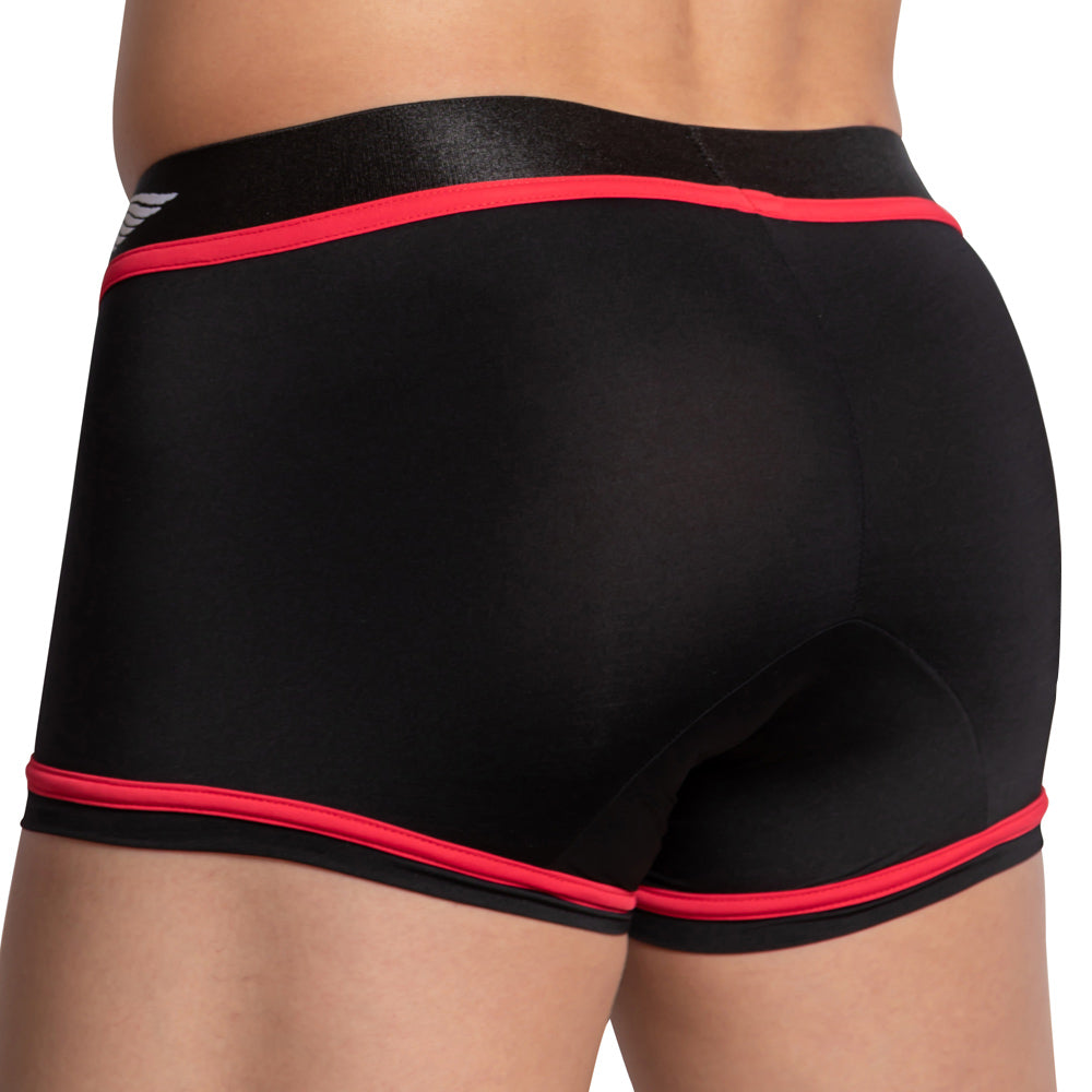 A person is wearing Agacios Bi-color Boxer Trunk, featuring snug black fabric with red trim and sleek stitching. The smooth texture and an elastic waistband with the Agacio logo on the left add to its style.