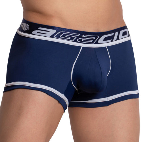 A person wearing the Agacio Bi-color Boxer Trunk, showcasing dark blue boxer briefs with sleek stitching and white trim, emphasized by Agacio on the elastic waistband. The focus is on the midsection, highlighting this stylish underwear.