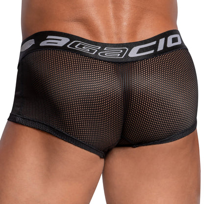 A close-up view of a person wearing Agacio Sheer Sides Boxer Trunk in black, showcasing the textured fabric and wide elastic waistband featuring the Agacio logo, viewed from the back.